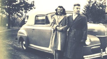 vintage photo of couple in front of a car