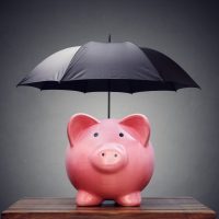 piggy bank with black umbrella over it