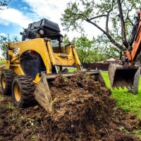 landscaping insurance - small bulldozer moving land