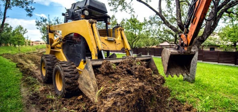 landscaping insurance - small bulldozer moving land