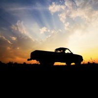 pickup truck insurance - pickup truck silhouette against a sunset