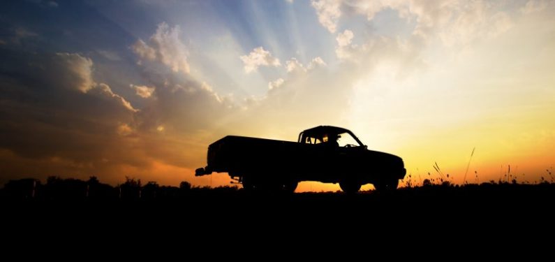 pickup truck insurance - pickup truck silhouette against a sunset