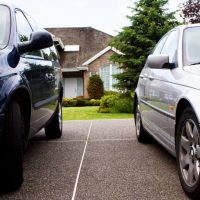 suv and a car in a driveway