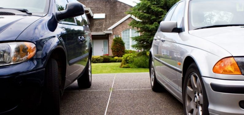 suv and a car in a driveway