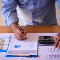 businessman with papers and calculator