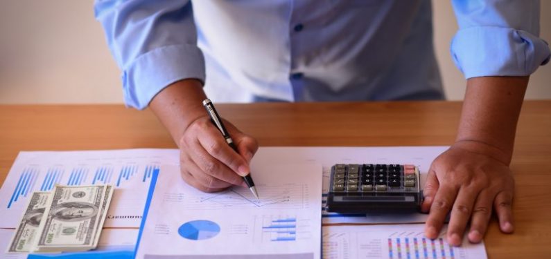 businessman with papers and calculator