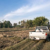 farm truck driving through a field