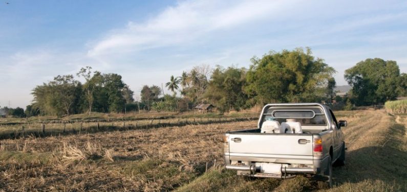 farm truck driving through a field