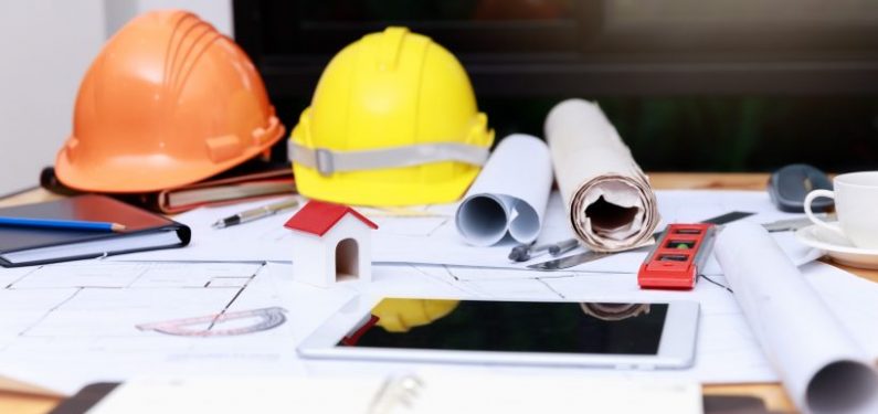 hard hats, blueprints, and designs on a table