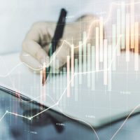 abstract financial graph with hand writing in notebook