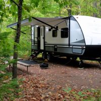 travel trailer set up at a campsite