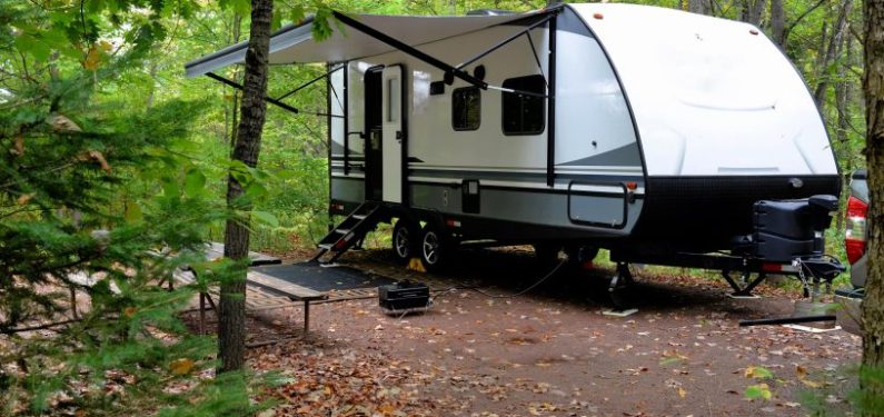 travel trailer set up at a campsite