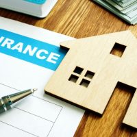 homeowners insurance form and model of a home