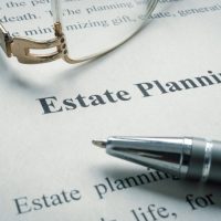 estate planning documents with a pair of glasses