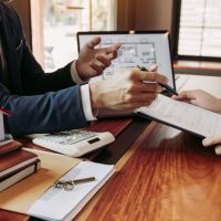 insurance agent reviewing homeowner's insurance with homeowner